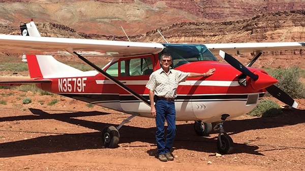 Paul Lyman standing next to his airplane