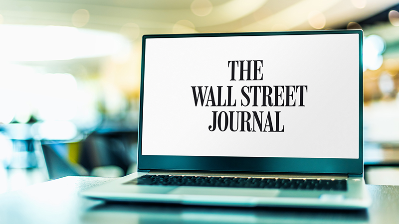 The Wall Street Journal displayed on a laptop. 